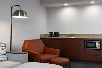 a waiting room with a chair and a sink at Courtyard Cleveland Beachwood in Beachwood
