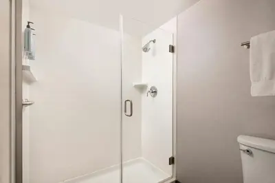 a shower with a glass door in a bathroom at Courtyard Cleveland Beachwood in Beachwood