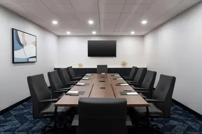 a conference room with a long table and chairs at Courtyard Cleveland Beachwood in Beachwood