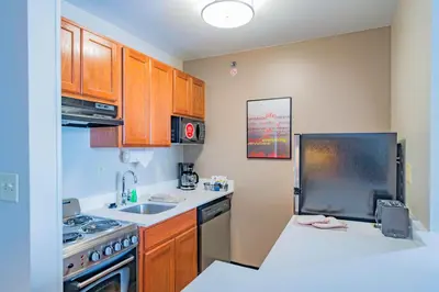 a kitchen with a sink and a stove top oven at TownePlace Suites Cleveland Streetsboro in Streetsboro