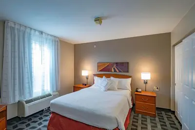 a hotel room with a bed and a window at TownePlace Suites Cleveland Streetsboro in Streetsboro