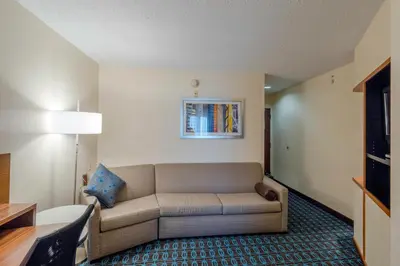 a living room with a couch in a hotel room at Fairfield Inn & Suites by Marriott Cleveland Streetsboro in Streetsboro