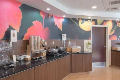 a kitchen with a counter with a flower mural on the wall at Fairfield Inn & Suites by Marriott Cleveland Streetsboro in Streetsboro