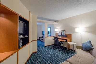 a hotel room with a desk and a room at Fairfield Inn & Suites by Marriott Cleveland Streetsboro in Streetsboro