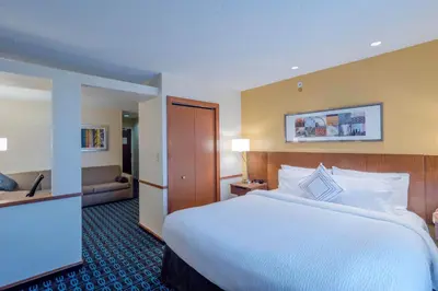 a hotel room with a large bed and a couch at Fairfield Inn & Suites by Marriott Cleveland Streetsboro in Streetsboro