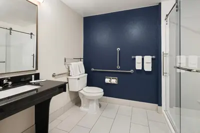a bathroom with a toilet and a blue wall at Fairfield Inn & Suites by Marriott Columbus East in Reynoldsburg