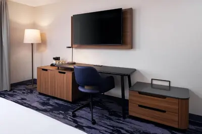 a room with a desk with a chair and a television at Fairfield Inn & Suites by Marriott Columbus East in Reynoldsburg