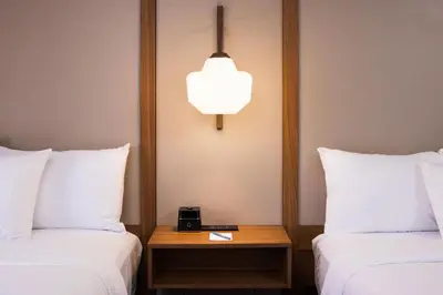 a hotel room with two beds and a table with a clock at Fairfield Inn & Suites by Marriott Columbus East in Reynoldsburg