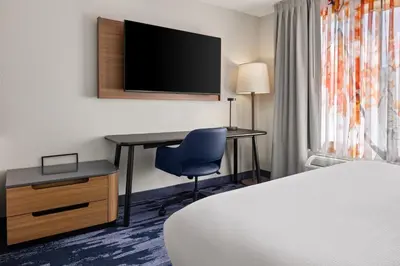 a hotel room with a desk and a tv at Fairfield Inn & Suites by Marriott Columbus East in Reynoldsburg