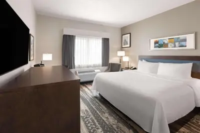 a hotel room with a bed and a flat screen tv at Wingate by Wyndham Marion in Marion