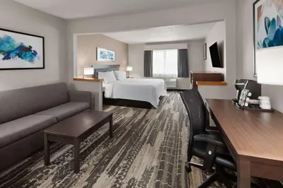 a hotel room with a bed and a couch at Wingate by Wyndham Marion in Marion