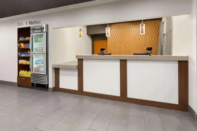 a food counter in a store with a refrigerator at Wingate by Wyndham Marion in Marion