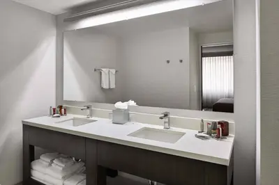 a bathroom with two sinks and a large mirror at Marriott Columbus Northwest in Dublin