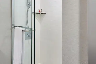 a shower with a glass door with a towel at Marriott Columbus Northwest in Dublin