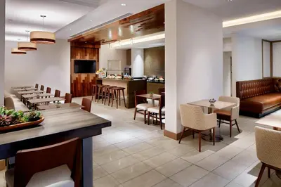 a restaurant with tables and chairs and a bar at Marriott Columbus Northwest in Dublin
