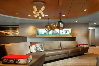a living room with a couch and a tv at SpringHill Suites Cincinnati North Forest Park in Springdale