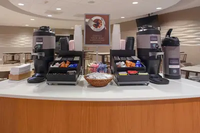 a counter with two coffee makers on top of it at SpringHill Suites Cincinnati North Forest Park in Springdale
