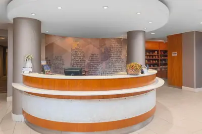 a lobby with a circular counter in a building at SpringHill Suites Cincinnati North Forest Park in Springdale