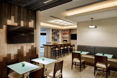 a restaurant with tables and chairs and a bar at Marriott Cincinnati North in West Chester