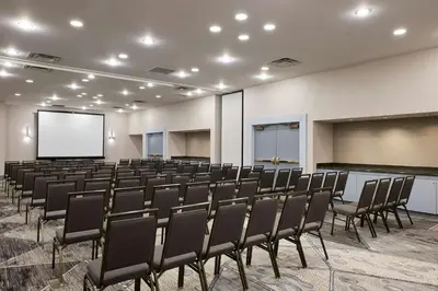 an empty room with chairs and a projection screen at Marriott Cincinnati North in West Chester