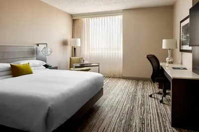 a hotel room with a bed and a desk at Marriott Cincinnati North in West Chester