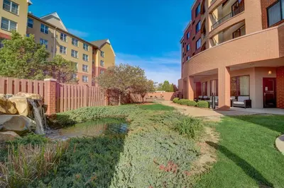 a garden with a waterfall in the middle of a building at Courtyard Cincinnati North at Union Centre in West Chester