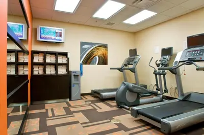 a gym with treadmills and elliptical machines at Courtyard Cincinnati North at Union Centre in West Chester