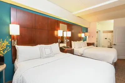 a hotel room with two beds with white pillows at Residence Inn Cincinnati North West Chester in West Chester