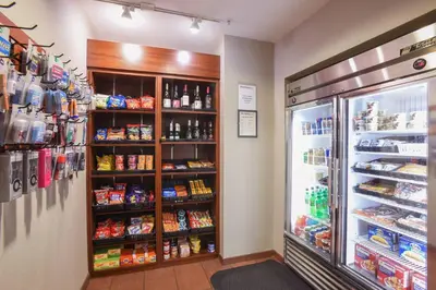 a grocery store aisle with a refrigerator and food at Residence Inn Cincinnati North West Chester in West Chester