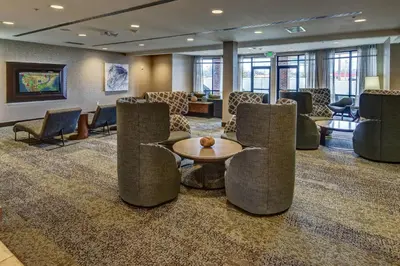 a lobby with chairs and a table in a room at Courtyard Lima in Lima