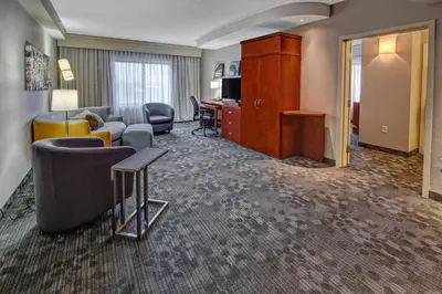a hotel room with a couch and a living room at Courtyard Lima in Lima
