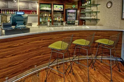 a bar with two chairs and a counter in a store at Courtyard Lima in Lima