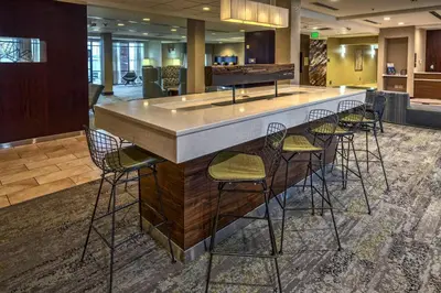 a bar in a hotel lobby with stools at Courtyard Lima in Lima