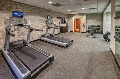 a gym with two treadmills and a treadmill at Courtyard Lima in Lima