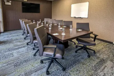 a conference room with a long table and chairs at Courtyard Lima in Lima