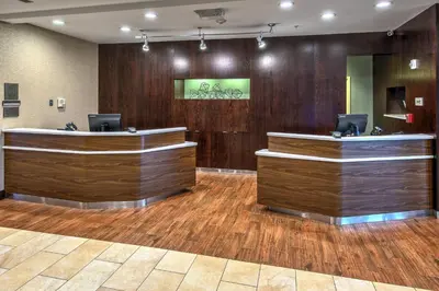 a lobby with wood paneling and reception desks at Courtyard Lima in Lima