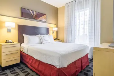 a hotel room with a bed and a window at TownePlace Suites Dayton North in Dayton