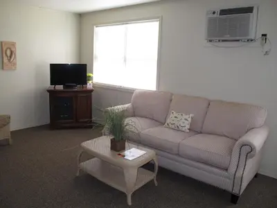 a living room with a couch and a table at Little Ted's Cottages in Marblehead