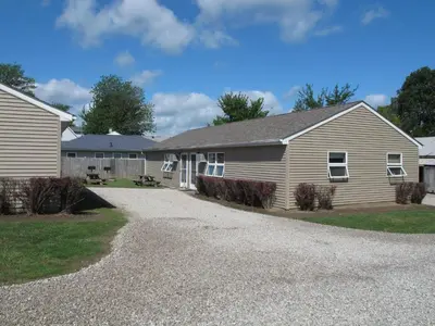 a house with a gravel driveway in front of it at Little Ted's Cottages in Marblehead