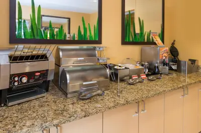 a kitchen with a counter with appliances on it at TownePlace Suites Huntington in Huntington