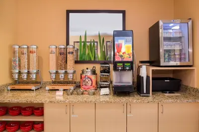 a counter with a refrigerator and a coffee maker at TownePlace Suites Huntington in Huntington