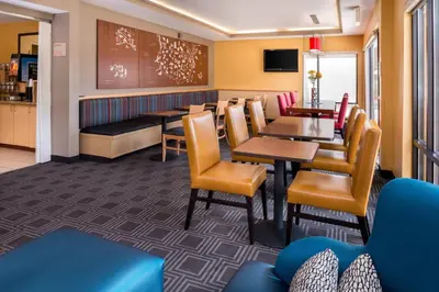 a restaurant with tables and chairs and a dining room at TownePlace Suites Huntington in Huntington