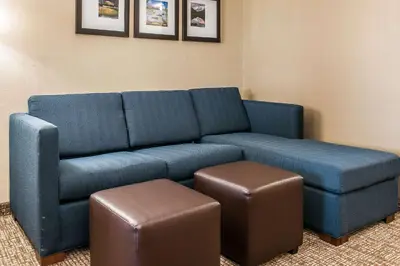 a blue couch and stool in a room at Comfort Inn & Suites Mount Sterling in Mount Sterling