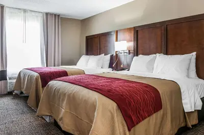 two beds in a hotel room with two at Comfort Inn & Suites Mount Sterling in Mount Sterling