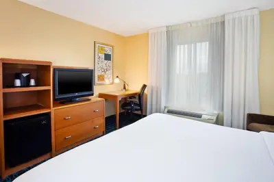 a hotel room with a bed and a television at Fairfield Inn & Suites by Marriott Lexington North in Lexington
