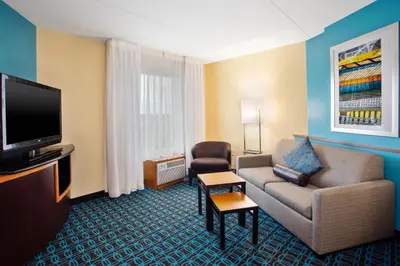 a living room with a couch and a tv at Fairfield Inn & Suites by Marriott Lexington North in Lexington