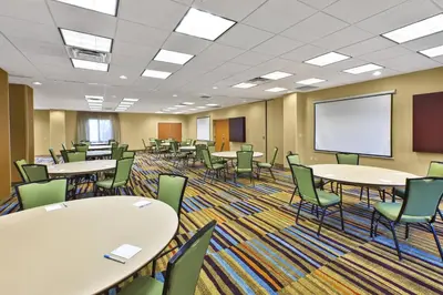 a classroom with tables and chairs and a whiteboard at Fairfield Inn & Suites by Marriott Lexington North in Lexington