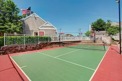 a tennis court in front of a house at Residence Inn by Marriott Lexington North in Lexington