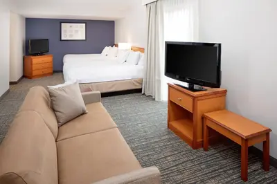 a hotel room with a couch and a tv and a bed at Residence Inn by Marriott Lexington North in Lexington