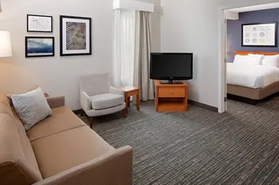 a hotel room with a couch and a bed and a television at Residence Inn by Marriott Lexington North in Lexington